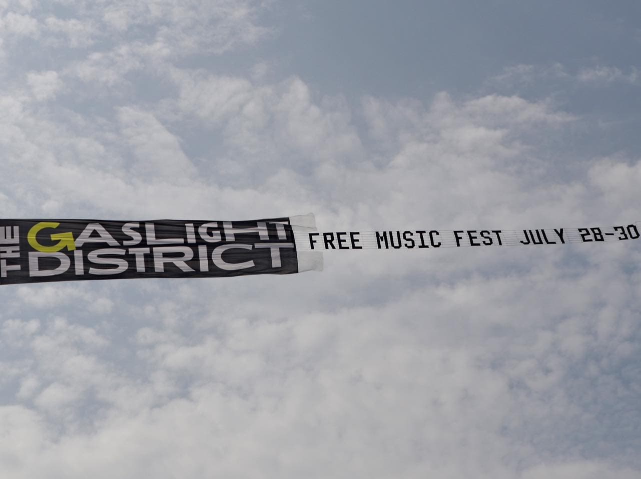 Gaslight District combo banner flying in the sky